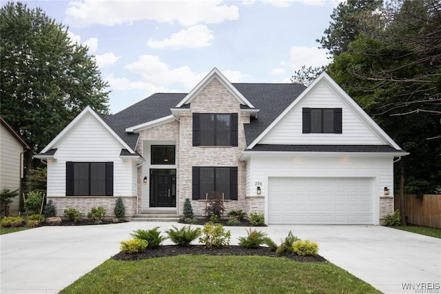 520 Paradise Rd, Amherst, NY 14051 - view of front facade with stone siding, concrete driveway, a garage, and a shingled roof