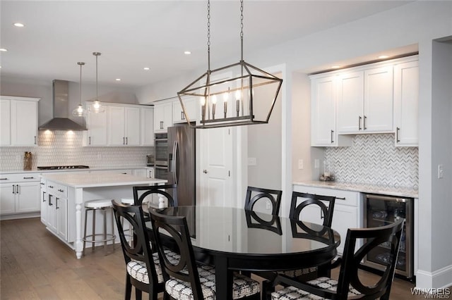 520 Paradise Rd, Amherst, NY 14051 - kitchen with wall chimney exhaust hood, beverage cooler, tasteful backsplash, stainless steel appliances, and recessed lighting