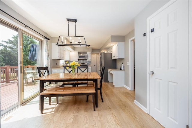 6 Barben Cir, Mendon, NY 14506 - dining area featuring a chandelier, light wood-style flooring, and baseboards