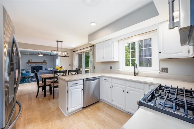 6 Barben Cir, Mendon, NY 14506 - kitchen with appliances with stainless steel finishes, light wood finished floors, a peninsula, and white cabinets