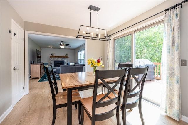 6 Barben Cir, Mendon, NY 14506 - dining space with light wood finished floors, a fireplace, a ceiling fan, and baseboards
