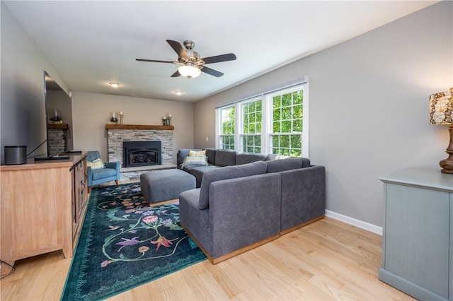 6 Barben Cir, Mendon, NY 14506 - living room featuring ceiling fan, light wood-style floors, baseboards, and a stone fireplace