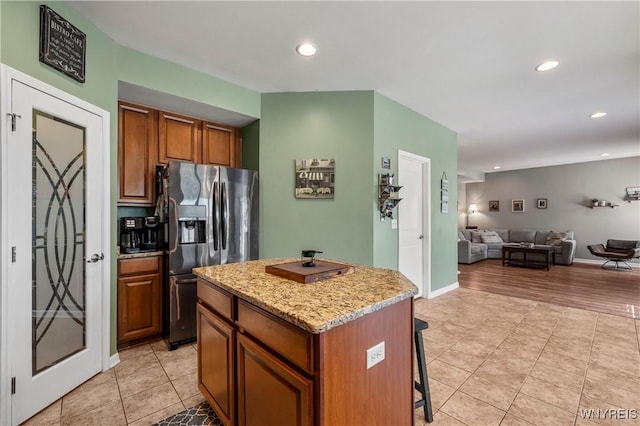 1 Skylark Ln, Wheatfield, NY 14304 - kitchen featuring stainless steel fridge with ice dispenser, recessed lighting, open floor plan, a kitchen island, and a kitchen bar
