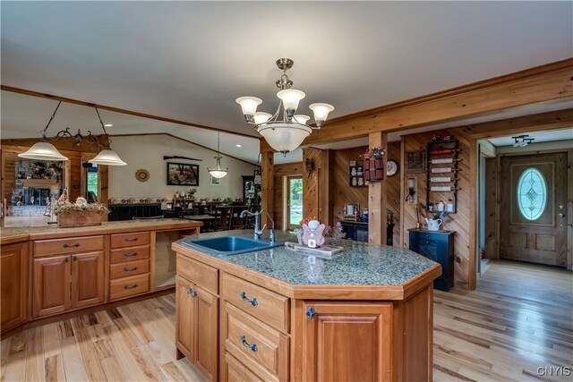 9758 E Rd, Denmark, NY 13367 - kitchen featuring a sink, wood walls, a chandelier, light wood-type flooring, and stainless steel dishwasher