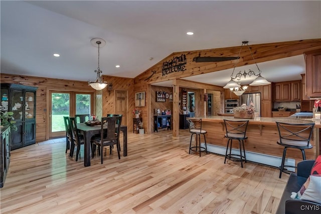 9758 E Rd, Denmark, NY 13367 - dining space featuring wood walls, lofted ceiling, light wood finished floors, a baseboard heating unit, and recessed lighting