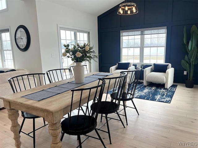 6401 Ward, Wheatfield, NY 14132 - dining space featuring vaulted ceiling, light wood finished floors, and a chandelier