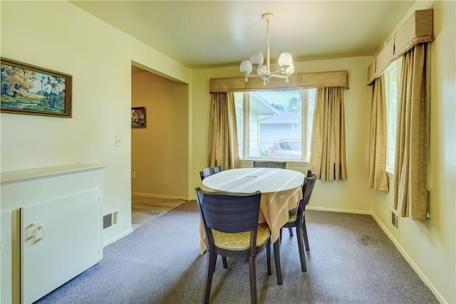 41 Leicestershire Rd, Irondequoit, NY 14621 - dining room featuring a chandelier, dark carpet, and baseboards