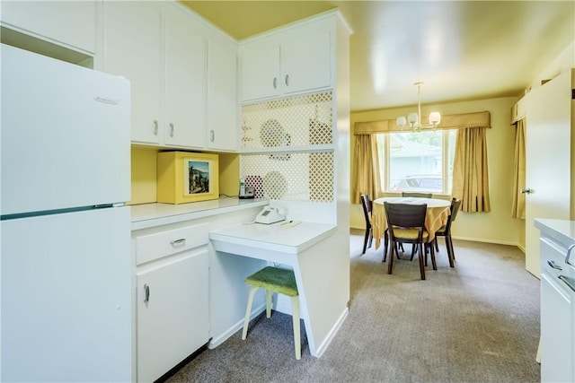 41 Leicestershire Rd, Irondequoit, NY 14621 - kitchen featuring freestanding refrigerator, a chandelier, light countertops, light carpet, and white cabinetry