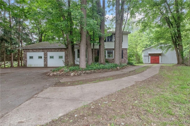 3643 Armstrong Rd, Camillus, NY 13209 - view of front of home with brick siding, an outbuilding, and driveway