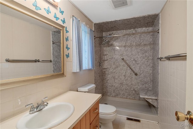 3643 Armstrong Rd, Camillus, NY 13209 - full bathroom featuring toilet, tile walls, vanity, a walk in shower, and backsplash