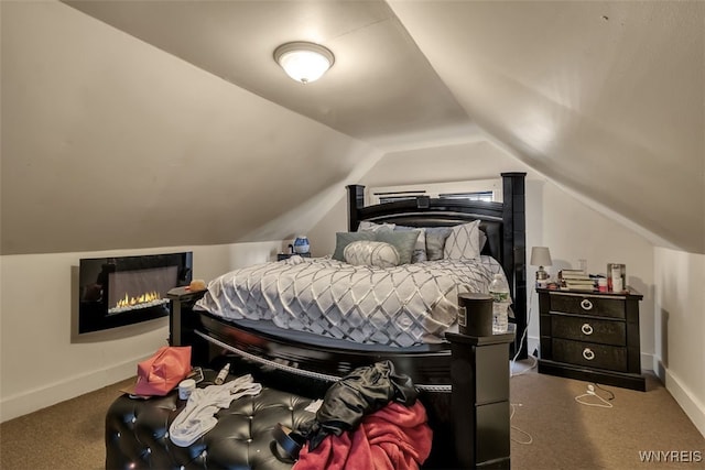 1244 Kenmore Ave, Buffalo, NY 14216 - carpeted bedroom with lofted ceiling, a lit fireplace, and baseboards