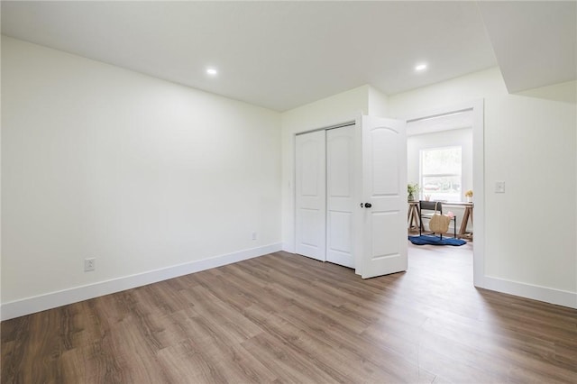 3908 Stalker Rd, Walworth, NY 14502 - unfurnished bedroom featuring wood finished floors, baseboards, recessed lighting, and a closet