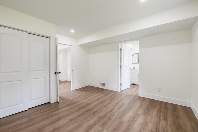 3908 Stalker Rd, Walworth, NY 14502 - below grade area with wood finished floors, baseboards, and recessed lighting