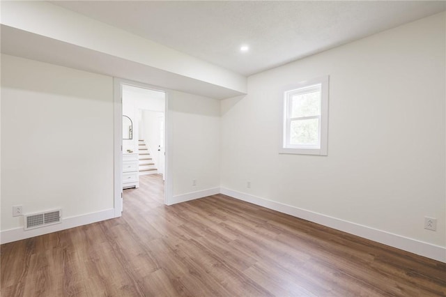 3908 Stalker Rd, Walworth, NY 14502 - below grade area with wood finished floors, baseboards, stairway, and recessed lighting