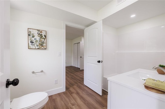 3908 Stalker Rd, Walworth, NY 14502 - bathroom with wood finished floors, vanity, toilet, baseboards, and recessed lighting