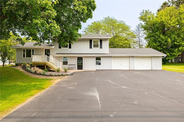 3908 Stalker Rd, Walworth, NY 14502 - split level home featuring asphalt driveway, an attached garage, and a front lawn