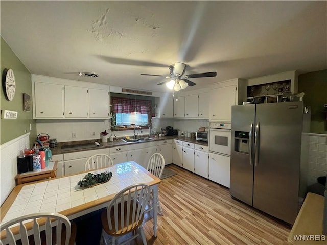 48 Ward Ct, Buffalo, NY 14220 - kitchen with stainless steel refrigerator with ice dispenser, oven, a sink, and white cabinetry