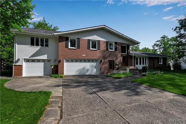 9325 Hunting Valley Rd N, Clarence, NY 14031 - tri-level home with an attached garage, concrete driveway, brick siding, and a front yard