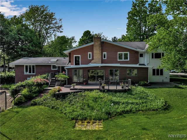 9325 Hunting Valley Rd N, Clarence, NY 14031 - back of property with a chimney, a wooden deck, and a lawn