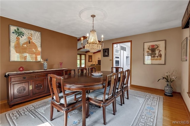 9325 Hunting Valley Rd N, Clarence, NY 14031 - dining room with a chandelier and light wood-type flooring