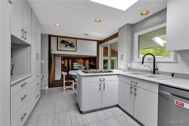 9325 Hunting Valley Rd N, Clarence, NY 14031 - kitchen featuring appliances with stainless steel finishes, light countertops, a peninsula, white cabinetry, and recessed lighting