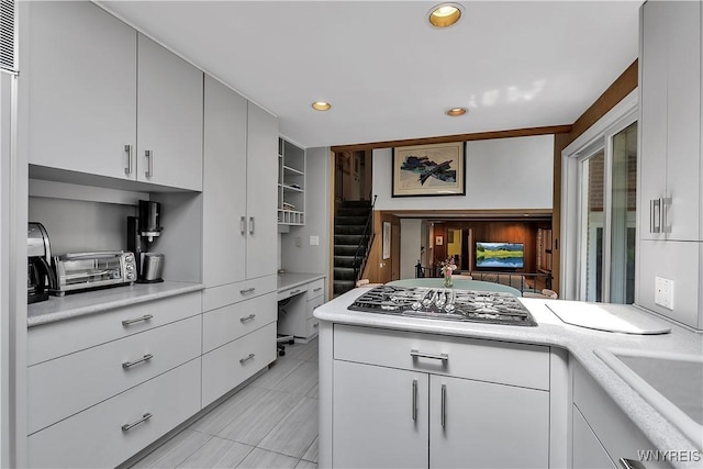 9325 Hunting Valley Rd N, Clarence, NY 14031 - kitchen featuring gas cooktop, light countertops, recessed lighting, white cabinetry, and light tile patterned floors