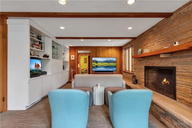 9325 Hunting Valley Rd N, Clarence, NY 14031 - living room with beamed ceiling, wooden walls, recessed lighting, a fireplace, and carpet flooring
