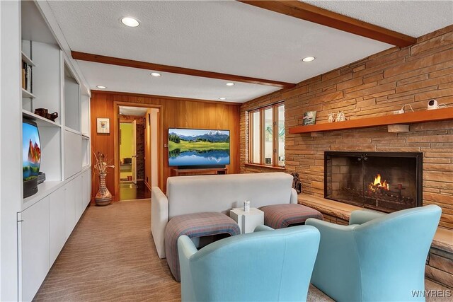 9325 Hunting Valley Rd N, Clarence, NY 14031 - living area featuring recessed lighting, beam ceiling, wooden walls, a textured ceiling, and a fireplace