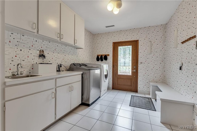 9325 Hunting Valley Rd N, Clarence, NY 14031 - washroom with cabinet space, washing machine and clothes dryer, light tile patterned floors, and wallpapered walls