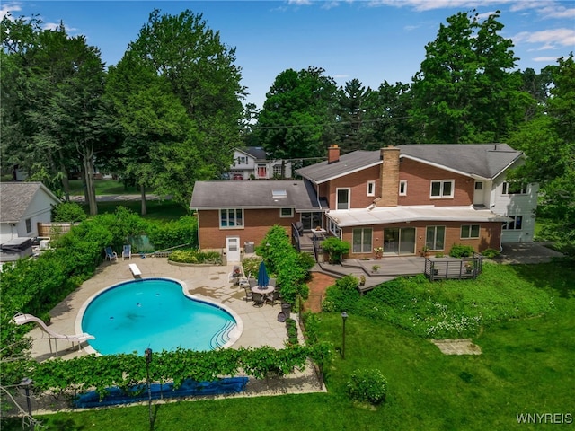 9325 Hunting Valley Rd N, Clarence, NY 14031 - back of house with a patio area, a chimney, an outdoor pool, and brick siding