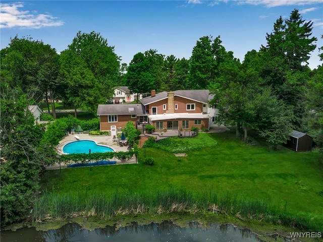 9325 Hunting Valley Rd N, Clarence, NY 14031 - rear view of property featuring an outdoor pool, a lawn, a patio, a chimney, and a storage shed