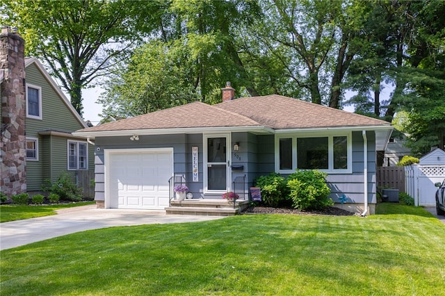 908 Winona Blvd, Irondequoit, NY 14617 - view of front facade featuring a garage, a chimney, driveway, and a shingled roof