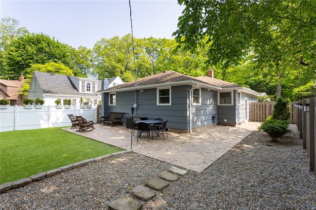 908 Winona Blvd, Irondequoit, NY 14617 - back of property with a chimney, a patio area, and roof with shingles