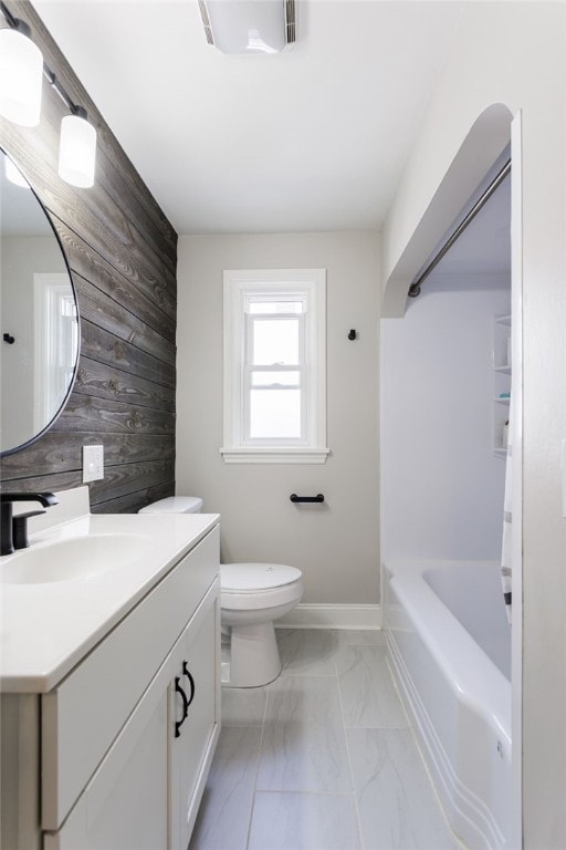 908 Winona Blvd, Irondequoit, NY 14617 - bathroom featuring wooden walls, vanity, marble look tile flooring, toilet, and shower / bath combination