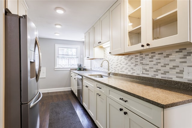 908 Winona Blvd, Irondequoit, NY 14617 - kitchen with appliances with stainless steel finishes, a sink, backsplash, and dark wood-style floors