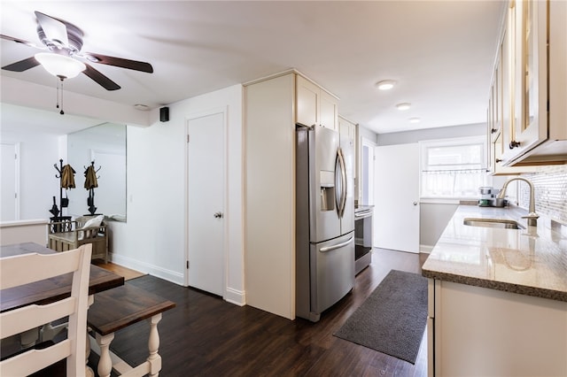 908 Winona Blvd, Irondequoit, NY 14617 - kitchen featuring stainless steel appliances, a sink, dark wood finished floors, light stone counters, and a ceiling fan