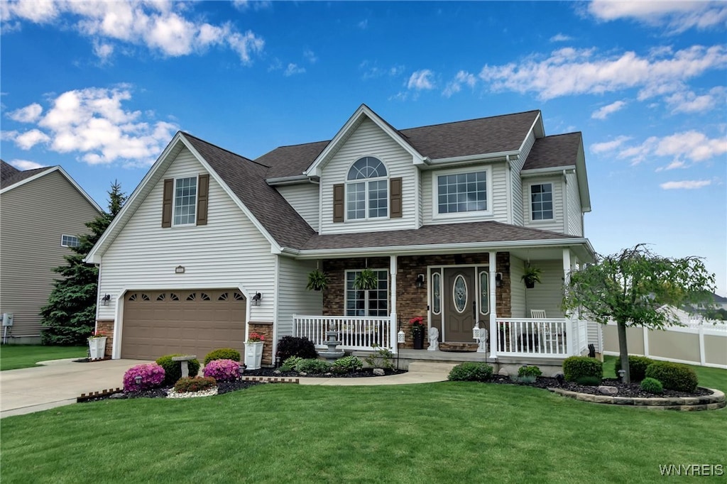 2781 Thornwoods Dr, Wheatfield, NY 14304 - view of front of home featuring covered porch, an attached garage, concrete driveway, and a front lawn