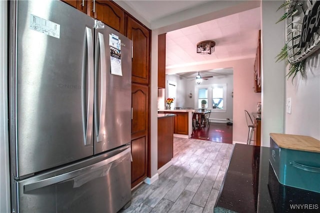 2019 Center St, North Collins, NY 14111 - kitchen with freestanding refrigerator, ceiling fan, light wood-style flooring, and brown cabinets
