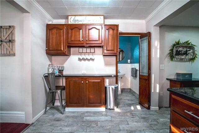 2019 Center St, North Collins, NY 14111 - kitchen featuring ornamental molding, baseboards, wood finished floors, and dark countertops
