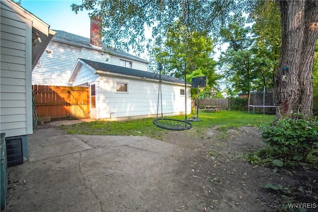2019 Center St, North Collins, NY 14111 - rear view of property with a trampoline, a patio, and a chimney