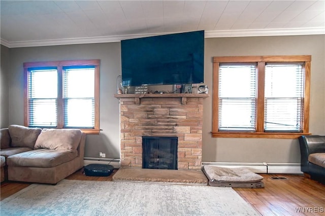 2019 Center St, North Collins, NY 14111 - living room featuring wood finished floors, baseboard heating, crown molding, and a fireplace