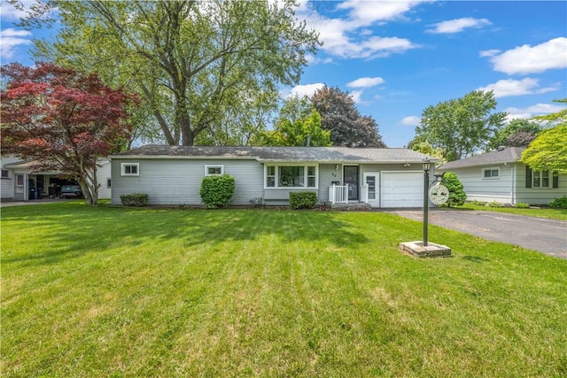 50 Loderdale Rd, Gates, NY 14624 - ranch-style house featuring an attached garage, asphalt driveway, and a front yard