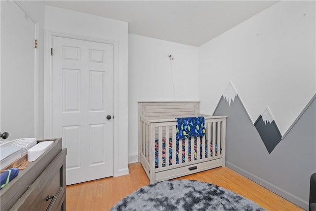 50 Loderdale Rd, Gates, NY 14624 - bedroom featuring wood finished floors and a crib