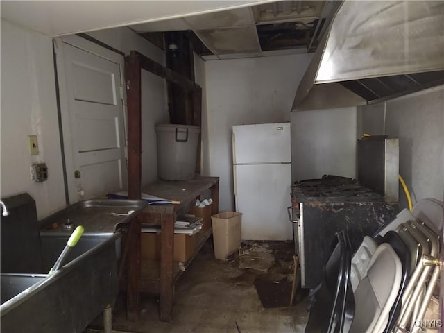 188 Main St, Cortland, NY 13045 - kitchen with freestanding refrigerator and unfinished concrete flooring