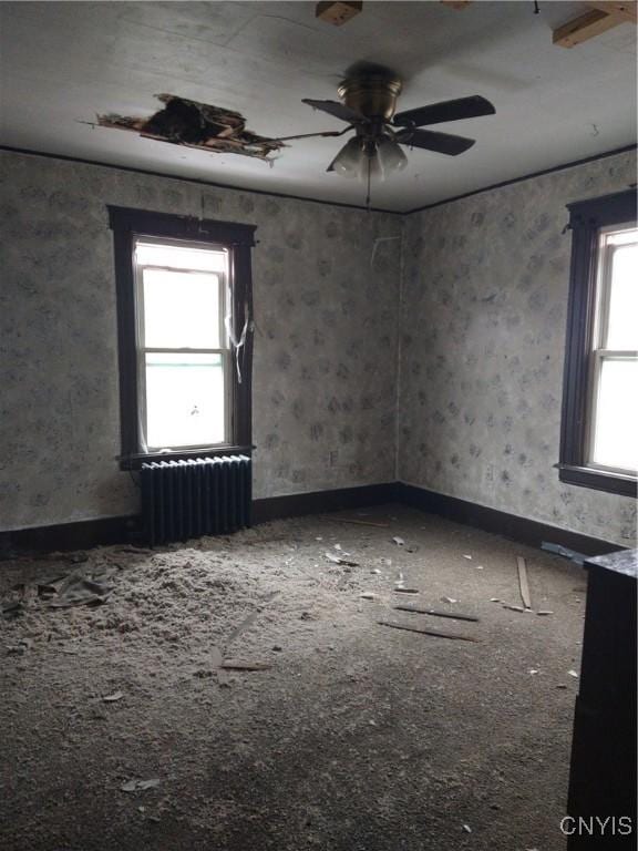 188 Main St, Cortland, NY 13045 - carpeted empty room featuring radiator and a ceiling fan