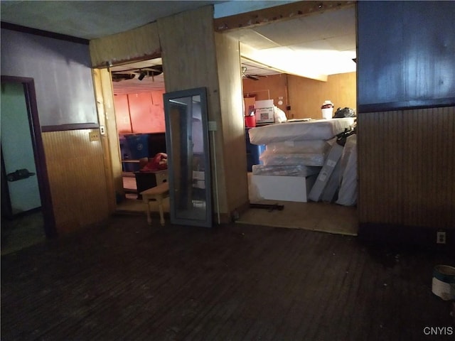 188 Main St, Cortland, NY 13045 - below grade area featuring wood finished floors, wooden walls, wainscoting, and ceiling fan