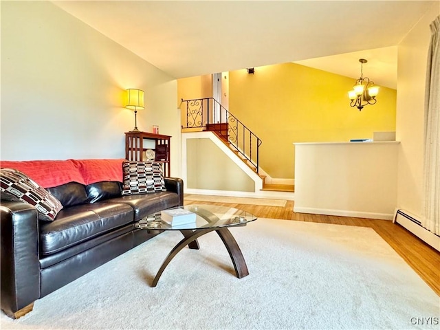 10 Litwak St, Fulton, NY 13069 - living area featuring wood finished floors, a chandelier, a baseboard heating unit, baseboards, and stairs