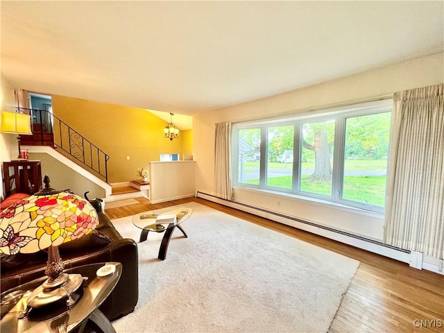 10 Litwak St, Fulton, NY 13069 - living room with baseboard heating, wood finished floors, a chandelier, stairs, and baseboards