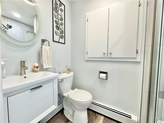 10 Litwak St, Fulton, NY 13069 - bathroom featuring a baseboard radiator, wood finished floors, vanity, toilet, and a shower