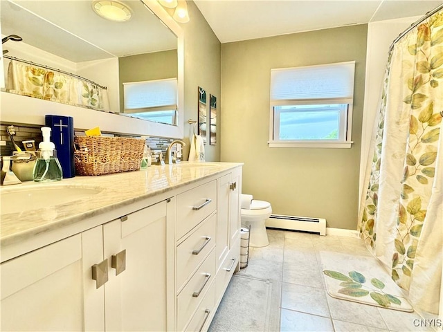 10 Litwak St, Fulton, NY 13069 - bathroom with a baseboard heating unit, double vanity, toilet, tile patterned floors, and baseboards